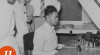Foto  Menteri Penerangan, Lumban Tobing (berpeci) didampingi Kepala Produksi Film Negara/PFN, R.M. Harjoto (paling kanan), melihat pembuatan film di Studio PFN, 11 Agustus 1953.